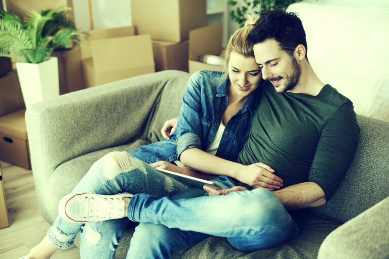 Couple sitting on the sofa in their new place